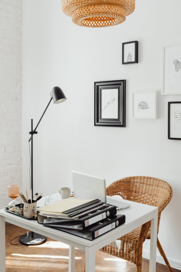 Elegant home office with wicker chair, white desk, and decor accents for a serene working space.